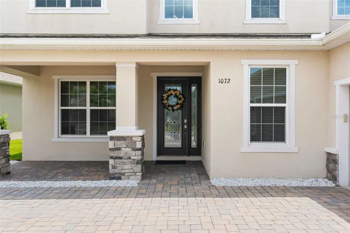 Paver driveway, covered front porch.