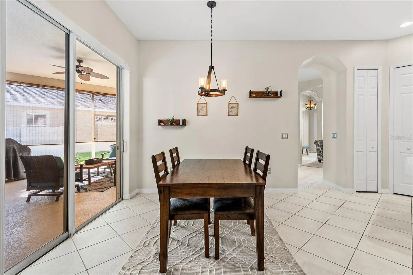 Sliding doors from the Dining area open to the COVERED & SCREENED LANAI, creating an effortless connection between indoor and outdoor living.