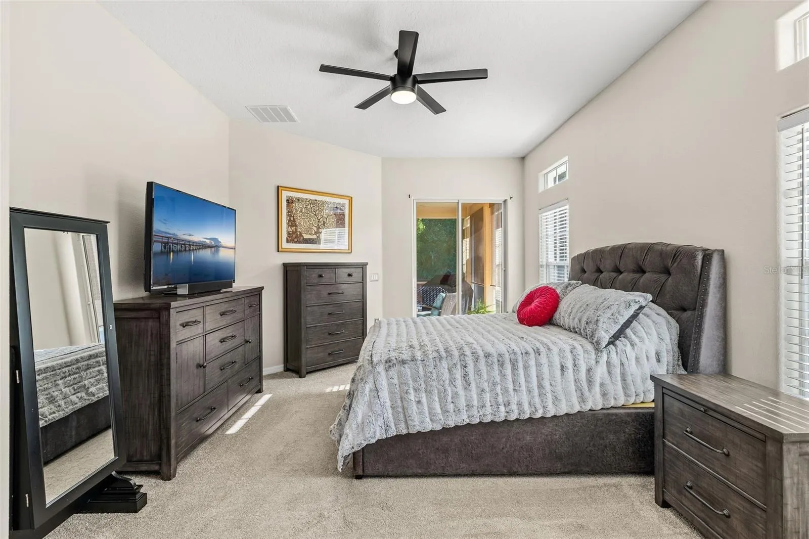 The spacious PRIMARY SUITE enjoys its own private wing and features sliding-door access to the rear lanai, DUAL WALK-IN CLOSETS and a well-appointed en-suite bath.