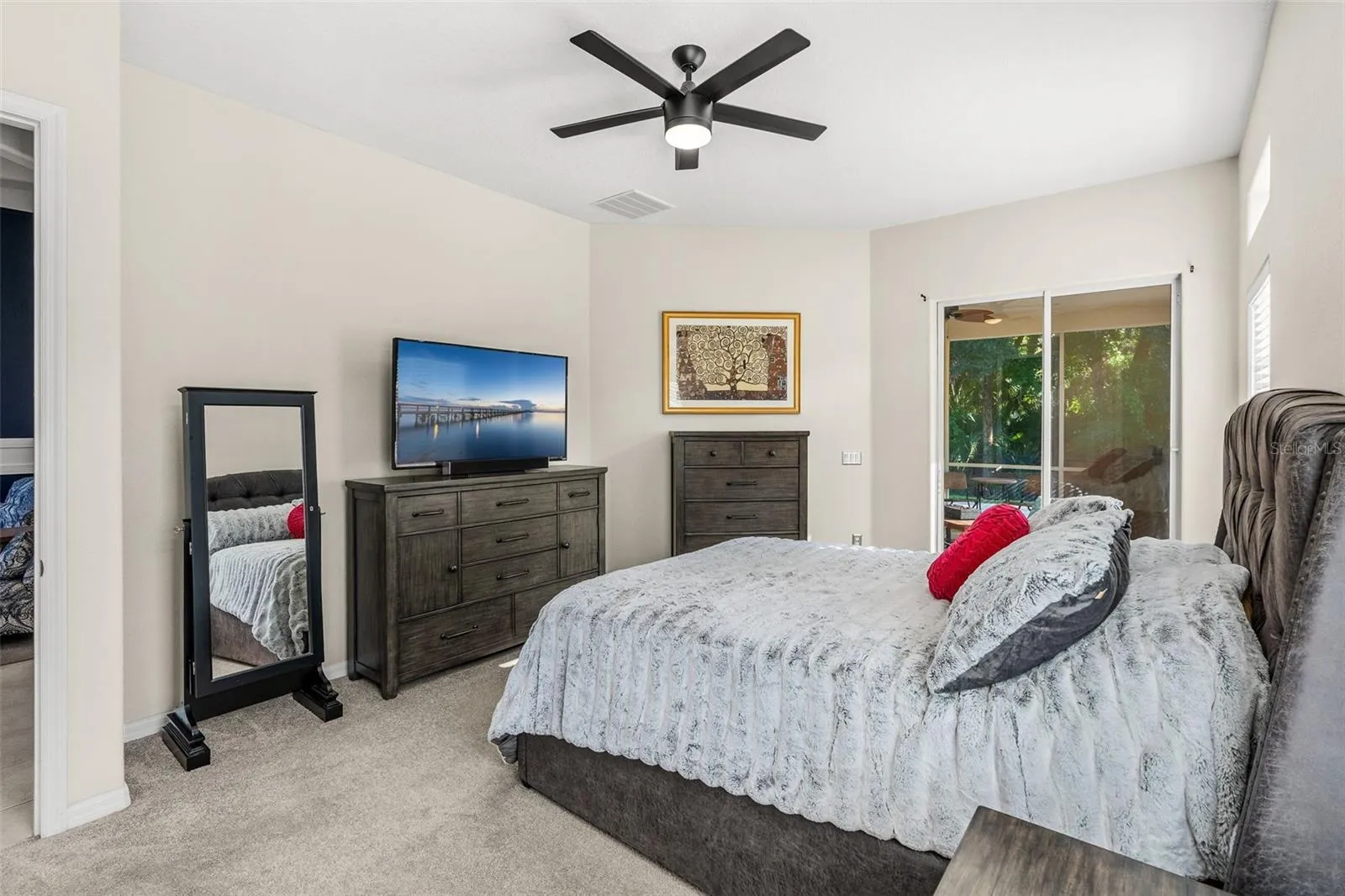 The spacious PRIMARY SUITE enjoys its own private wing and features sliding-door access to the rear lanai, DUAL WALK-IN CLOSETS and a well-appointed en-suite bath.
