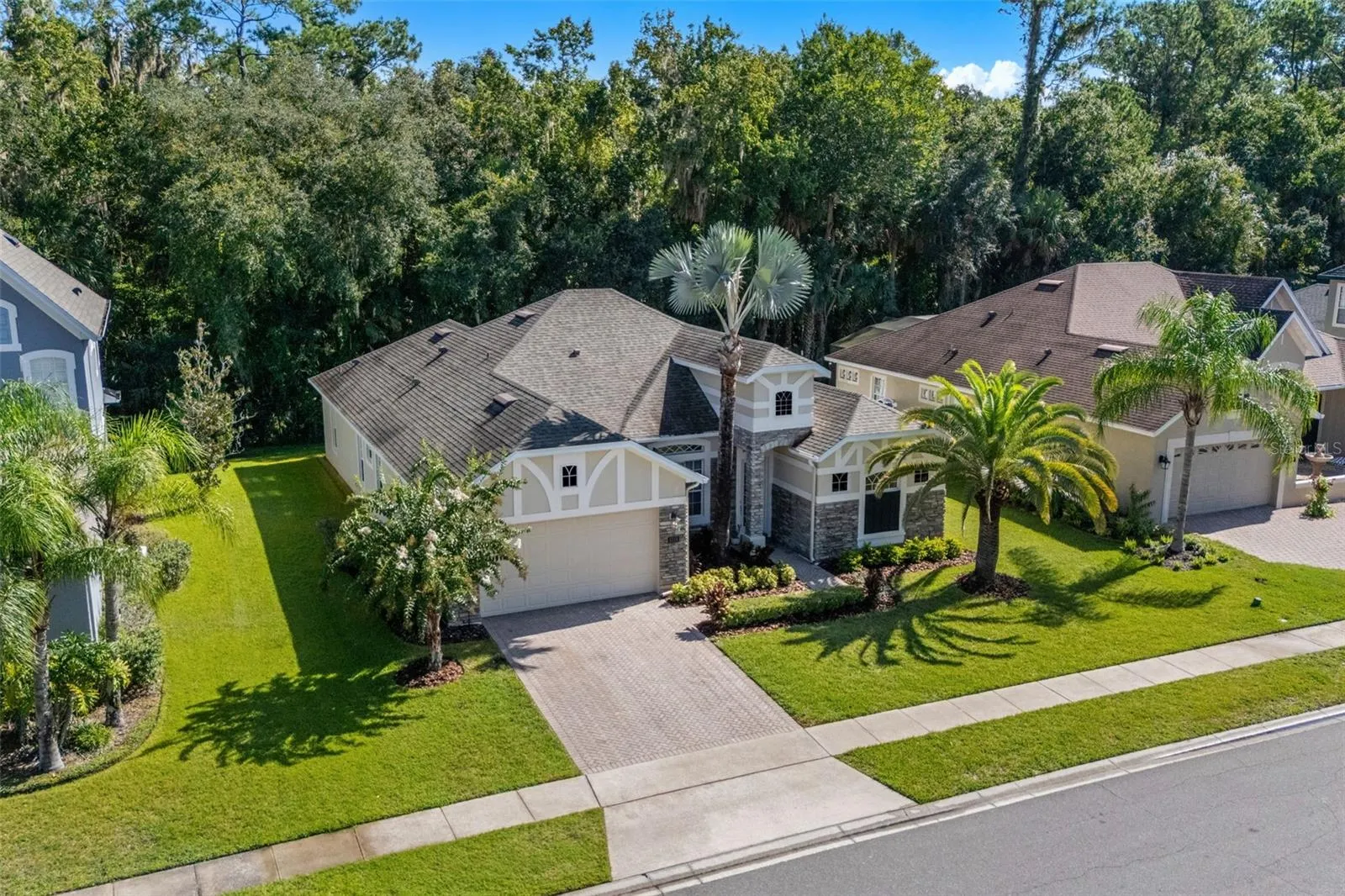 From the moment you arrive, the curb appeal makes a lasting impression with FRESH LANDSCAPING (2026), STONE-FACED ACCENTS and a BRICK-PAVER DRIVEWAY leading to the 2-CAR GARAGE.