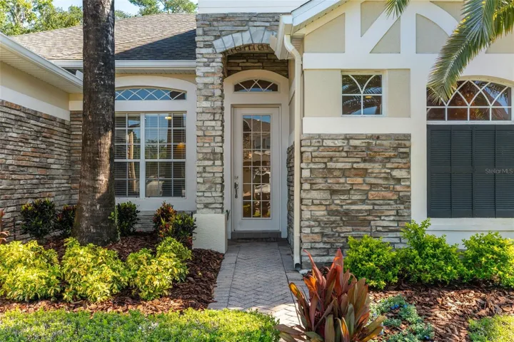 From the moment you arrive, the curb appeal makes a lasting impression with FRESH LANDSCAPING (2026), STONE-FACED ACCENTS and a BRICK-PAVER DRIVEWAY leading to the 2-CAR GARAGE.