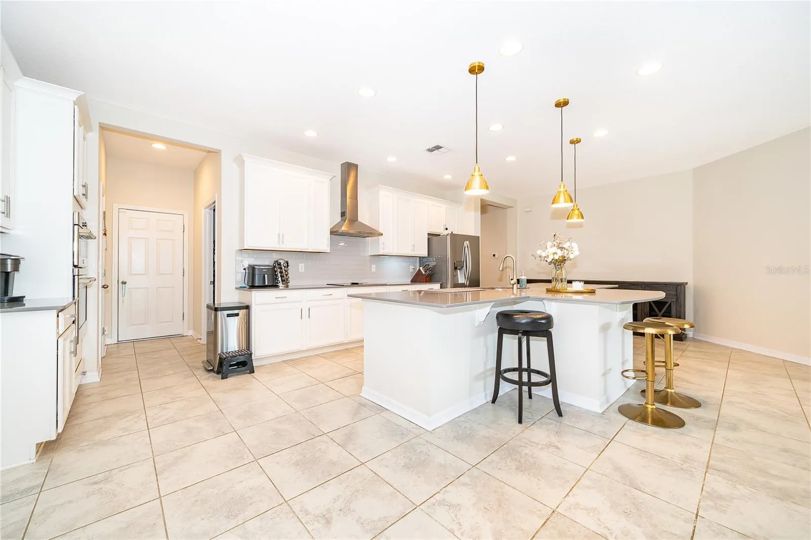 Oversized island provides an ideal gathering point for casual meals, entertaining, and everyday family life.