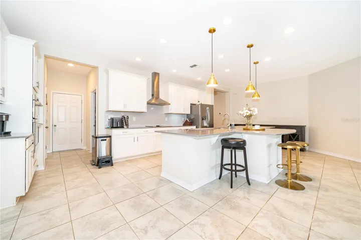 Oversized island provides an ideal gathering point for casual meals, entertaining, and everyday family life.