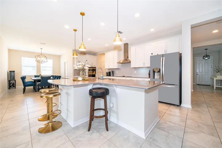 Beautifully appointed gourmet kitchen featuring abundant cabinetry, generous counter space, and a large center island.