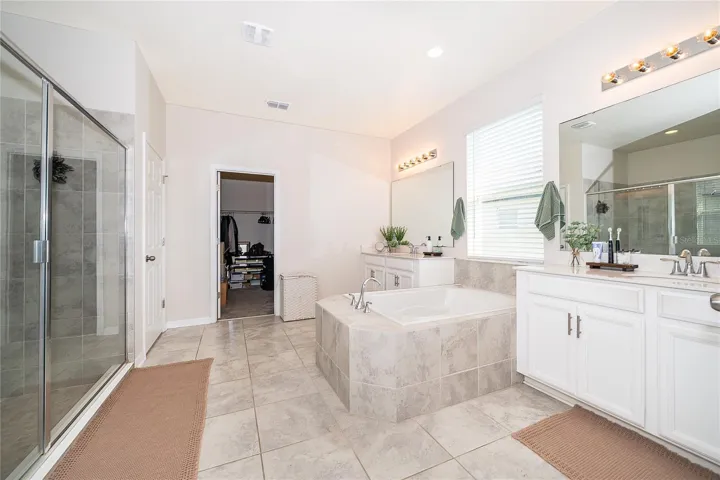 Beautifully appointed primary bath designed to create a private spa-like retreat.