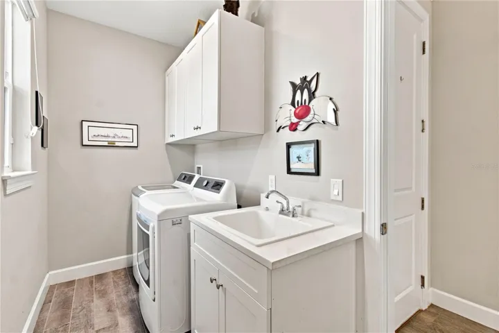 LAUNDRY ROOM W/CUSTOM SINK AND STORAGE CABINETS