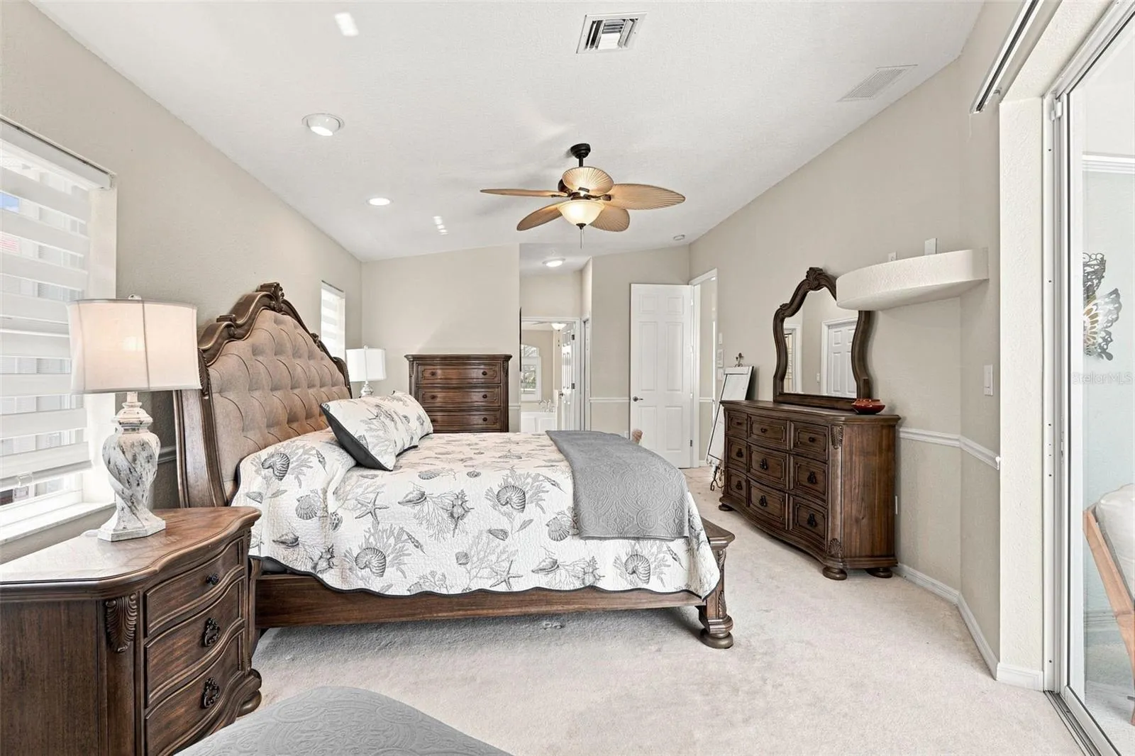 Spacious Primary Suite with Sliding Doors to Pool