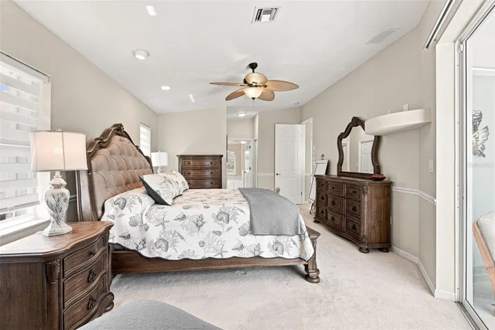 Spacious Primary Suite with Sliding Doors to Pool