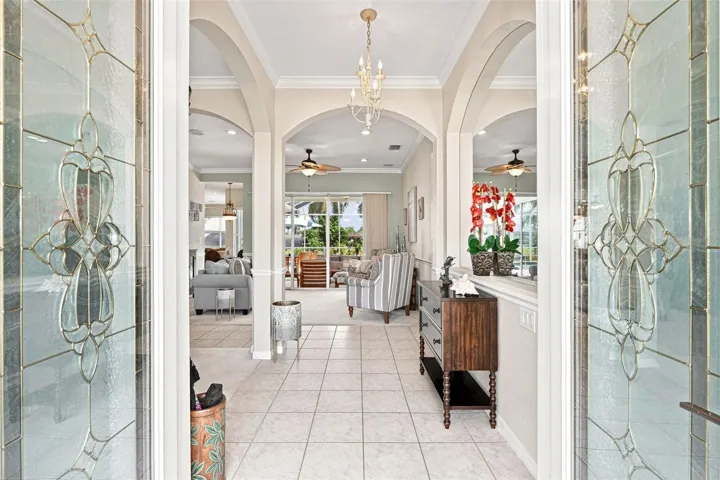 Elegant Foyer with Arched Details &amp; Leaded Glass Double Doors