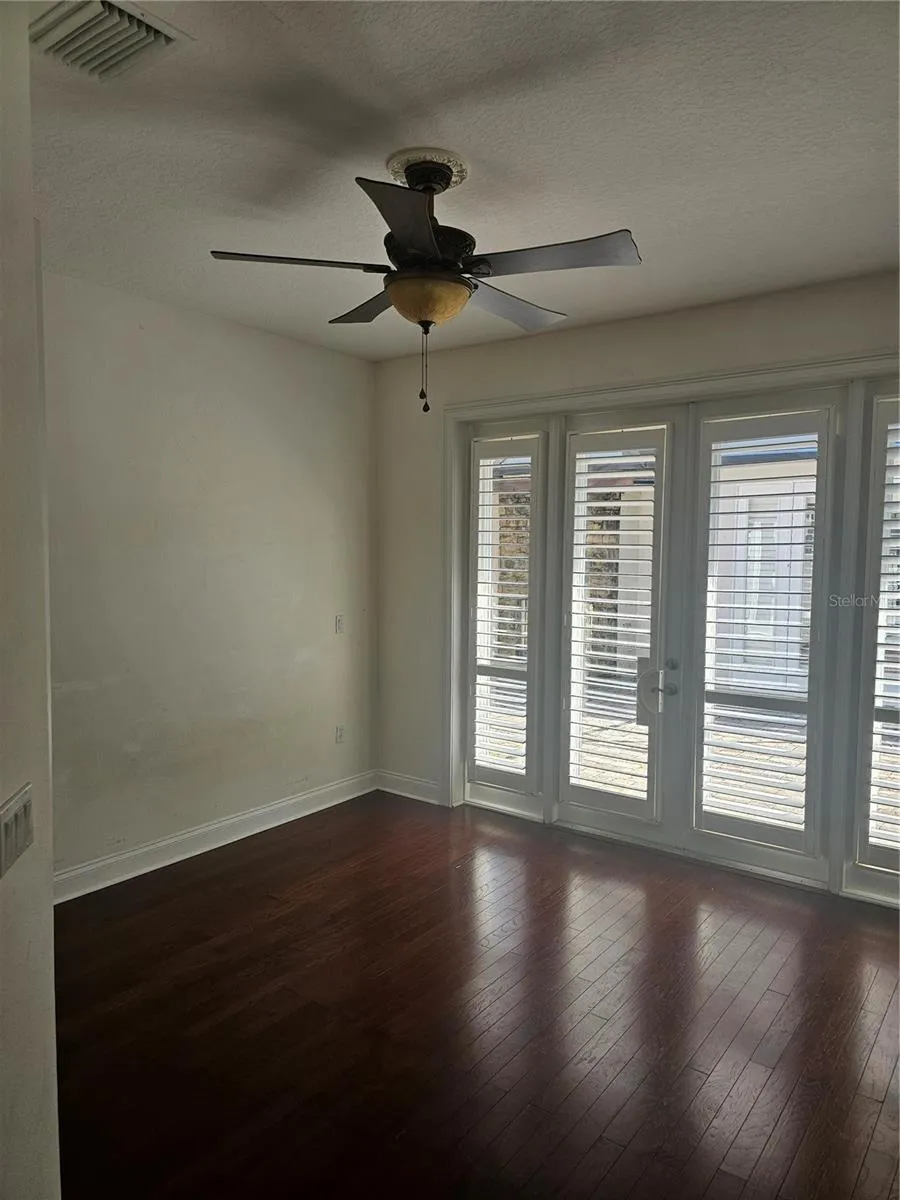 Double doors with Bermuda blinds leading to courtyard