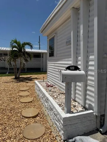 Front of Mobile Home with stepping stones and nice landscaping