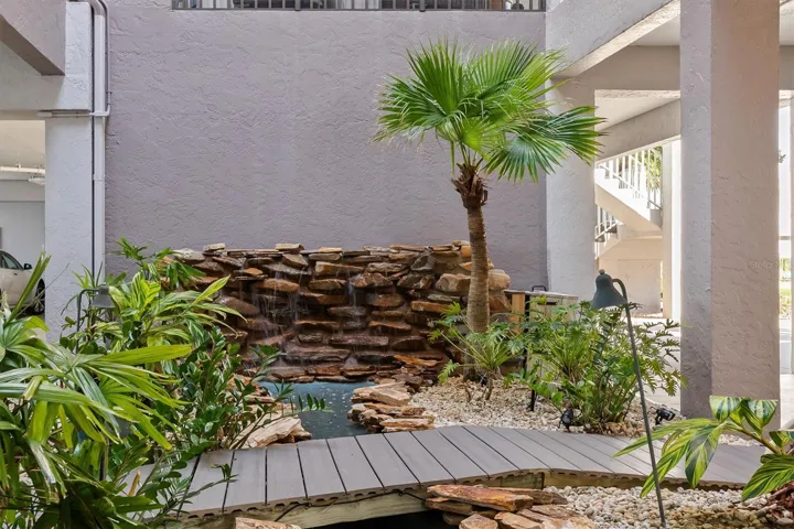 Step bridge from parking to elevator over fountain