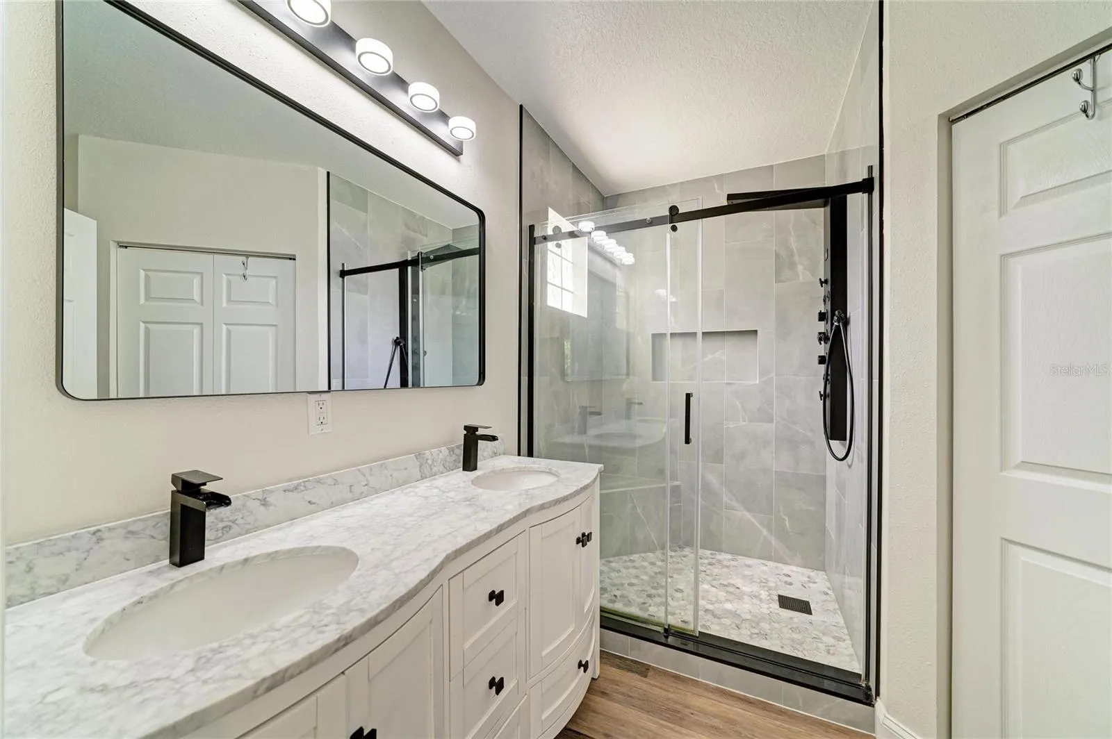 Primary ensuite bathroom has been newly remodeled with double sink vanity and new shower.