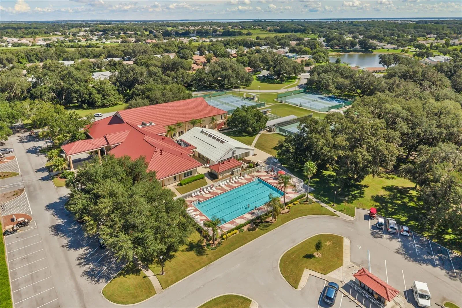 Clubhouse with outdoor pool, tennis, pickle ball and bocce ball courts