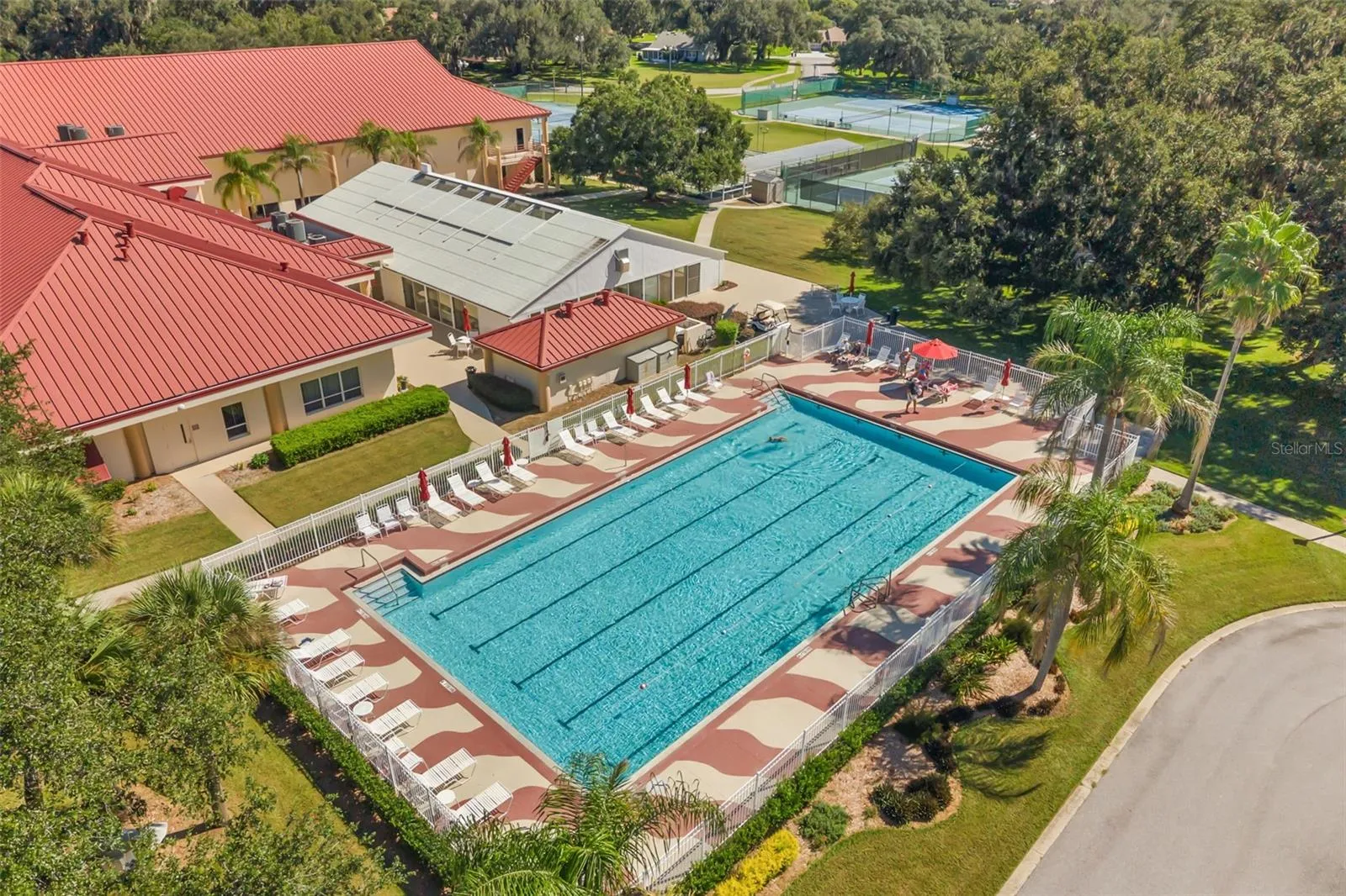 Clubhouse with outdoor pool, tennis, pickle ball and bocce ball courts