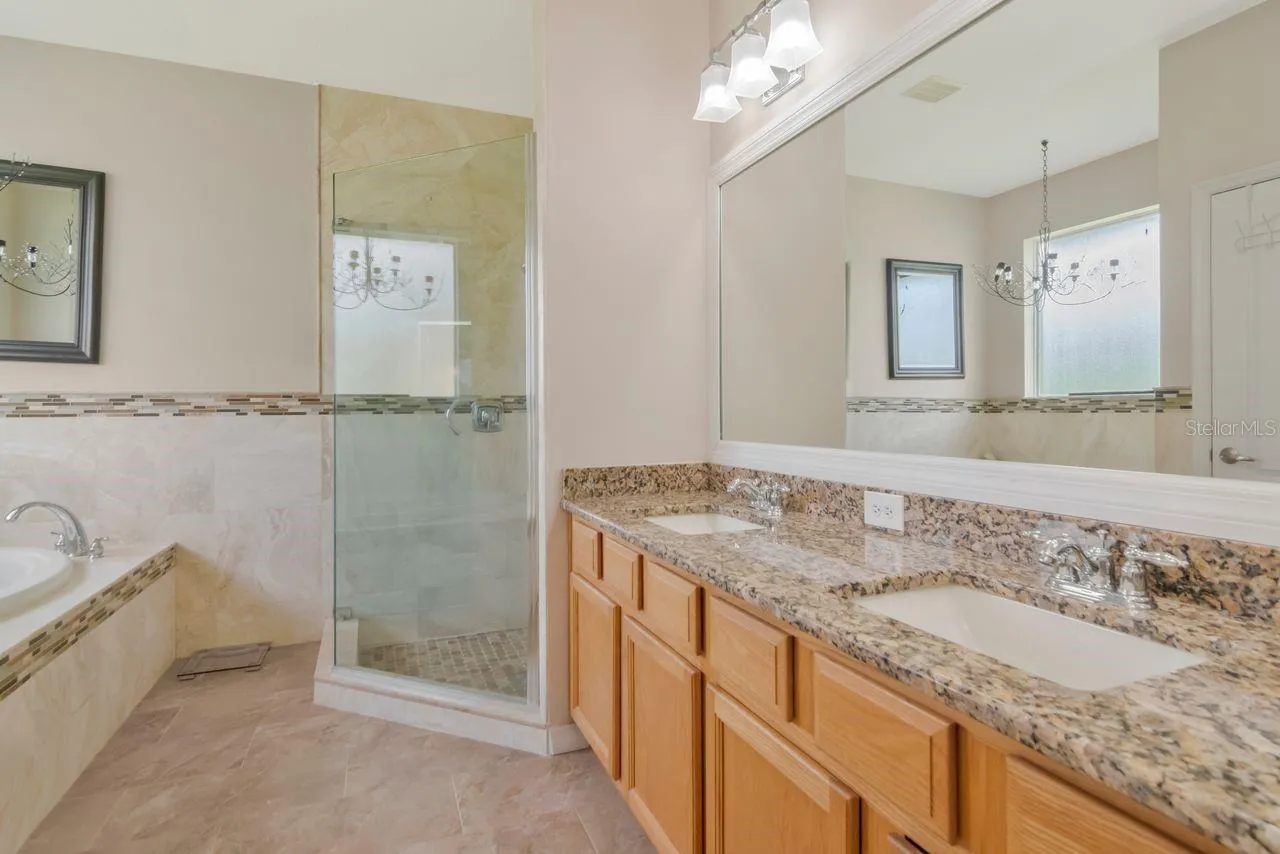 Updated Primary Ensuite with Dual Vanities, Garden Tub, Frameless Walk in Shower and Private Water Closet