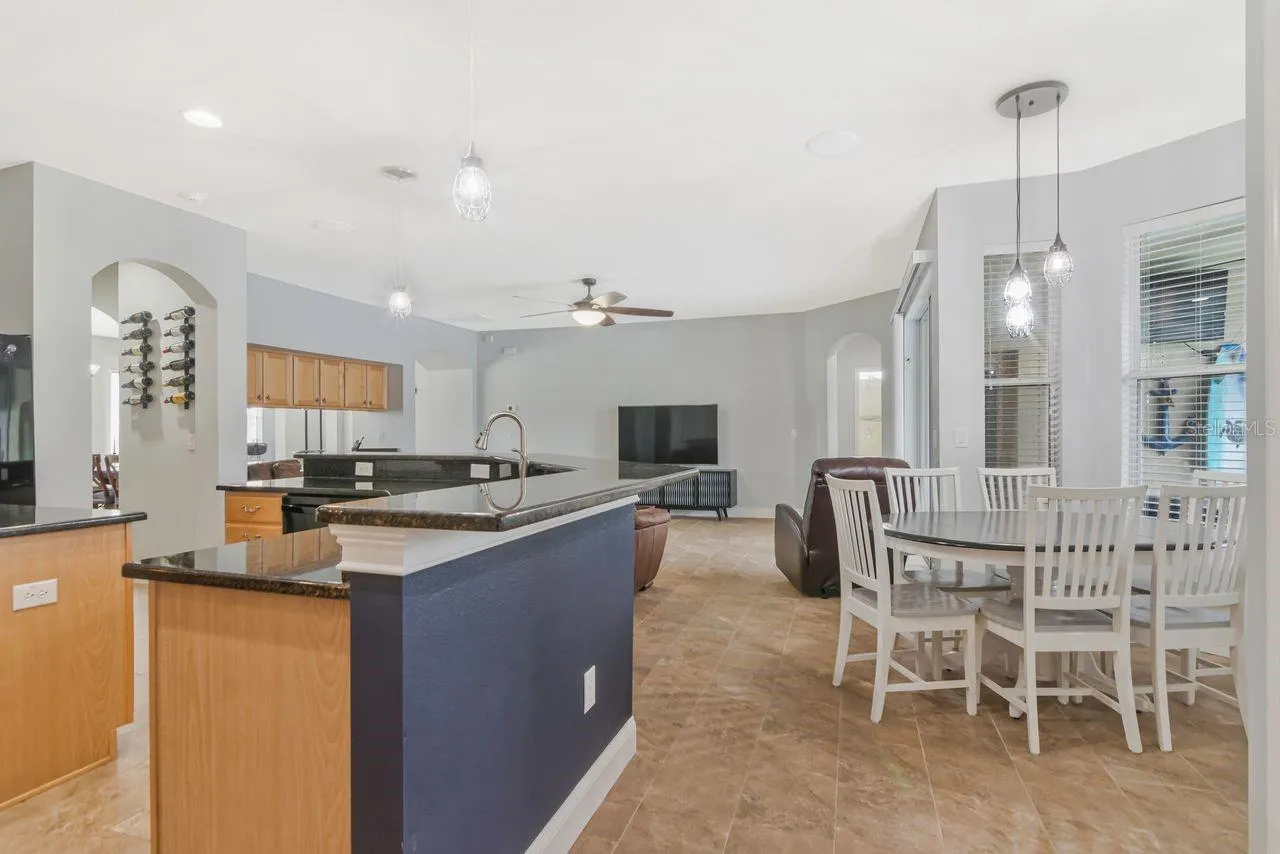 Breakfast bar for 6 plus eat in kitchen space with lots of natural light and pool and pond views.