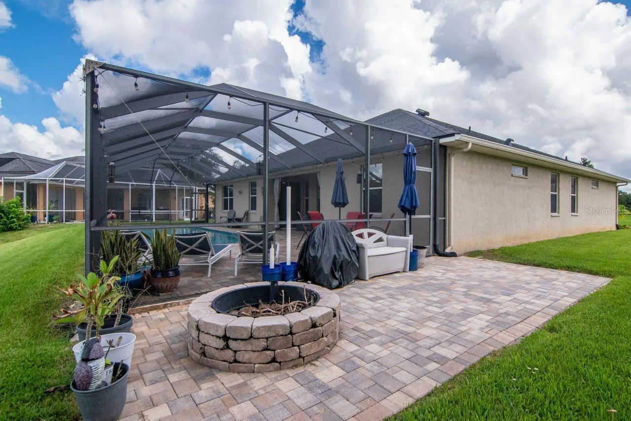 Extended paver lanai with fire pit.