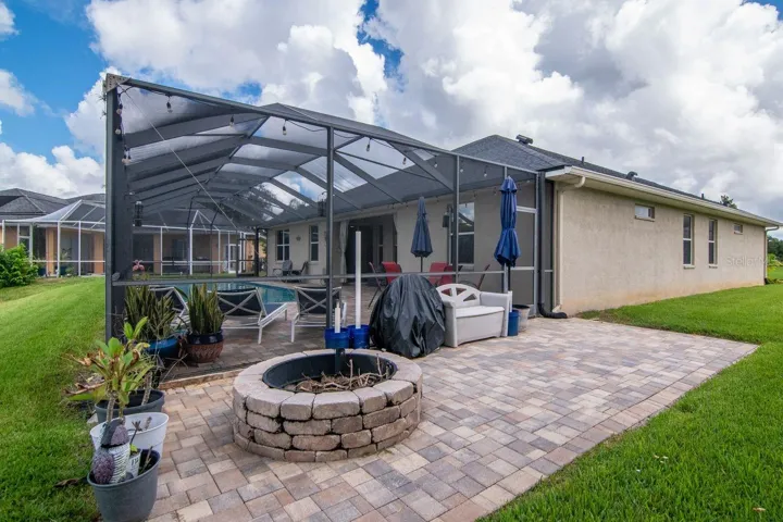 Extended paver lanai with fire pit.