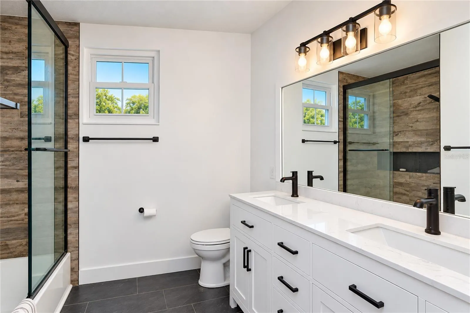 Fully remodeled bathroom features a double vanity
