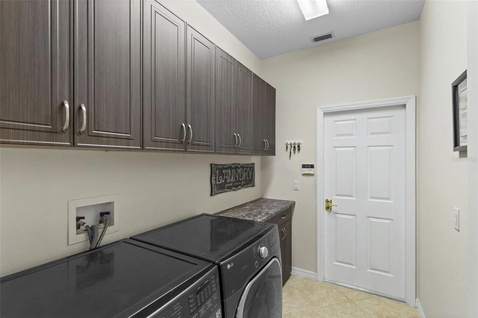 Interior Laundry w. Cabinets and Counter Space