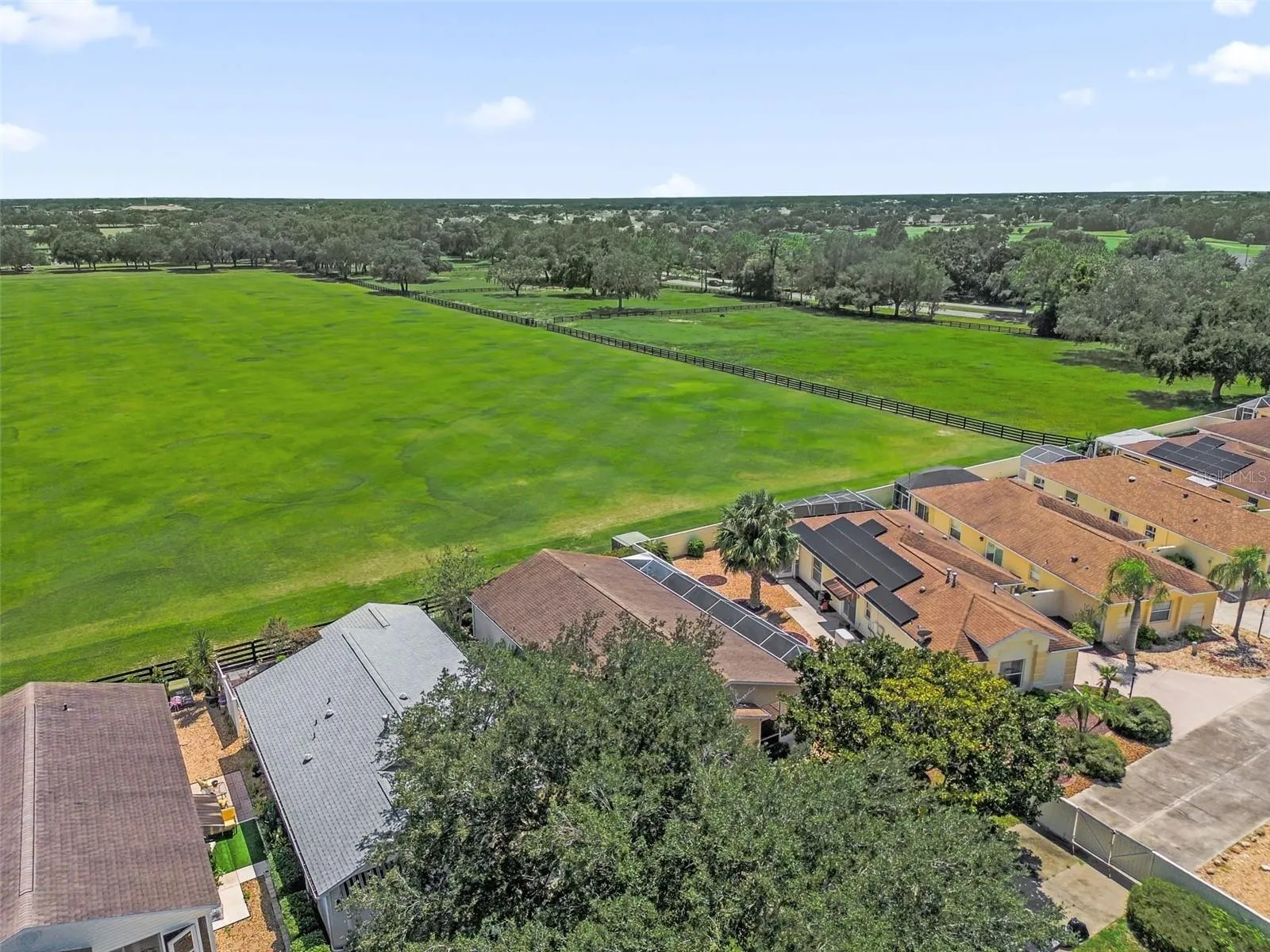 Drone view showcasing the home and the adjacent polo field.