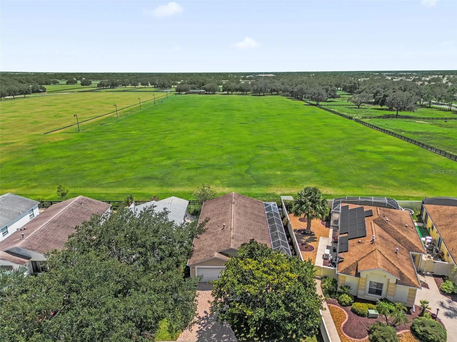 Drone view showcasing the home and the adjacent polo field.