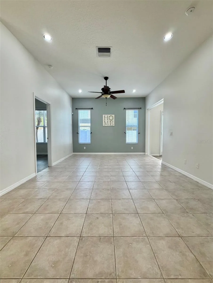 Straight ahead, down the hall, you see the living room.  It's more spacious than this photo portrays.