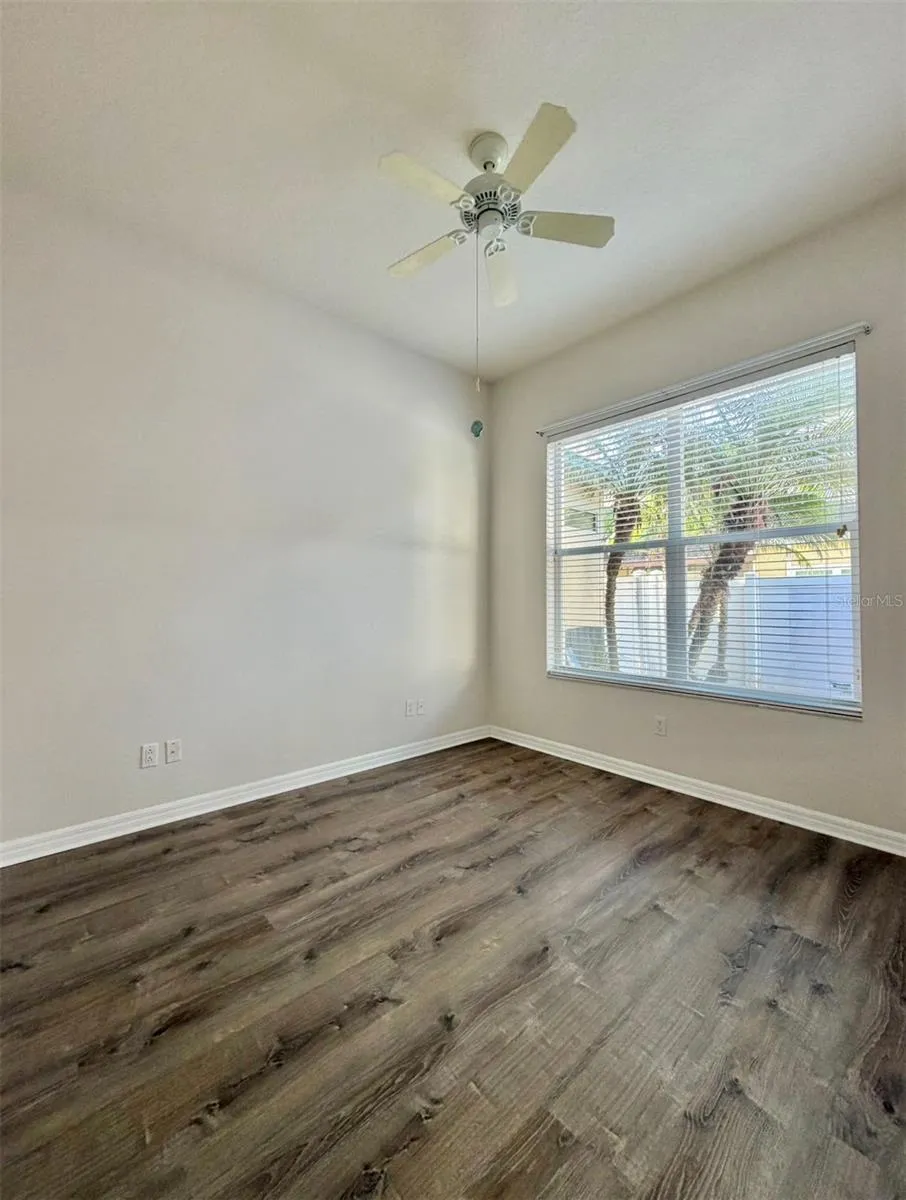 Bedroom 3 overlooks the back patio and features a ceiling fan and an extra-wide closet.