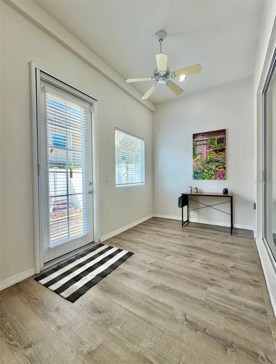 The closed-in back sunroom can be used as an office or a sitting room, or even the grandkids play space!  The door leads to the private back patio and yard.
