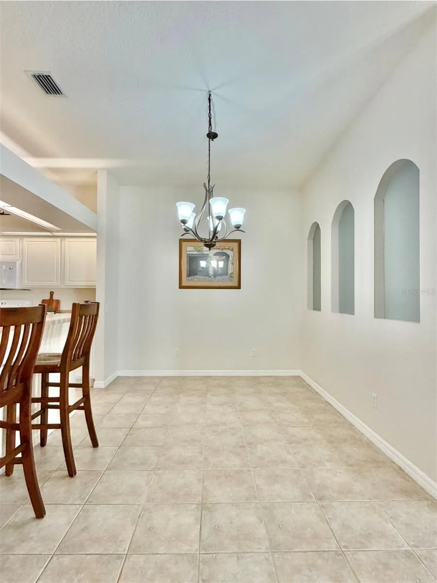 The dining room is spacious and can fit a large table.