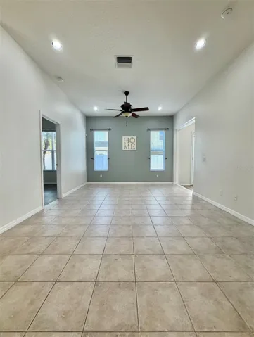 Straight ahead, down the hall, you see the living room.  It's more spacious than this photo portrays.