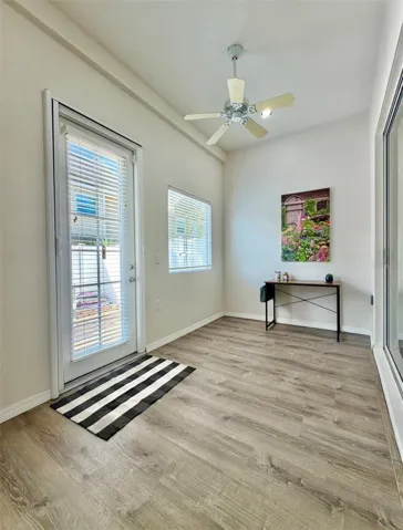 The closed-in back sunroom can be used as an office or a sitting room, or even the grandkids play space!  The door leads to the private back patio and yard.
