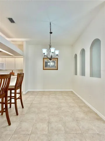 The dining room is spacious and can fit a large table.