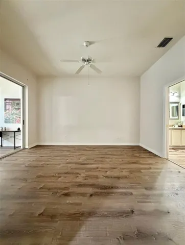 The Primary Bedroom is really spacious and has a sliding glass door to the closed-in patio, which can be easy access to an office space.  The ensuite is seen to the right.