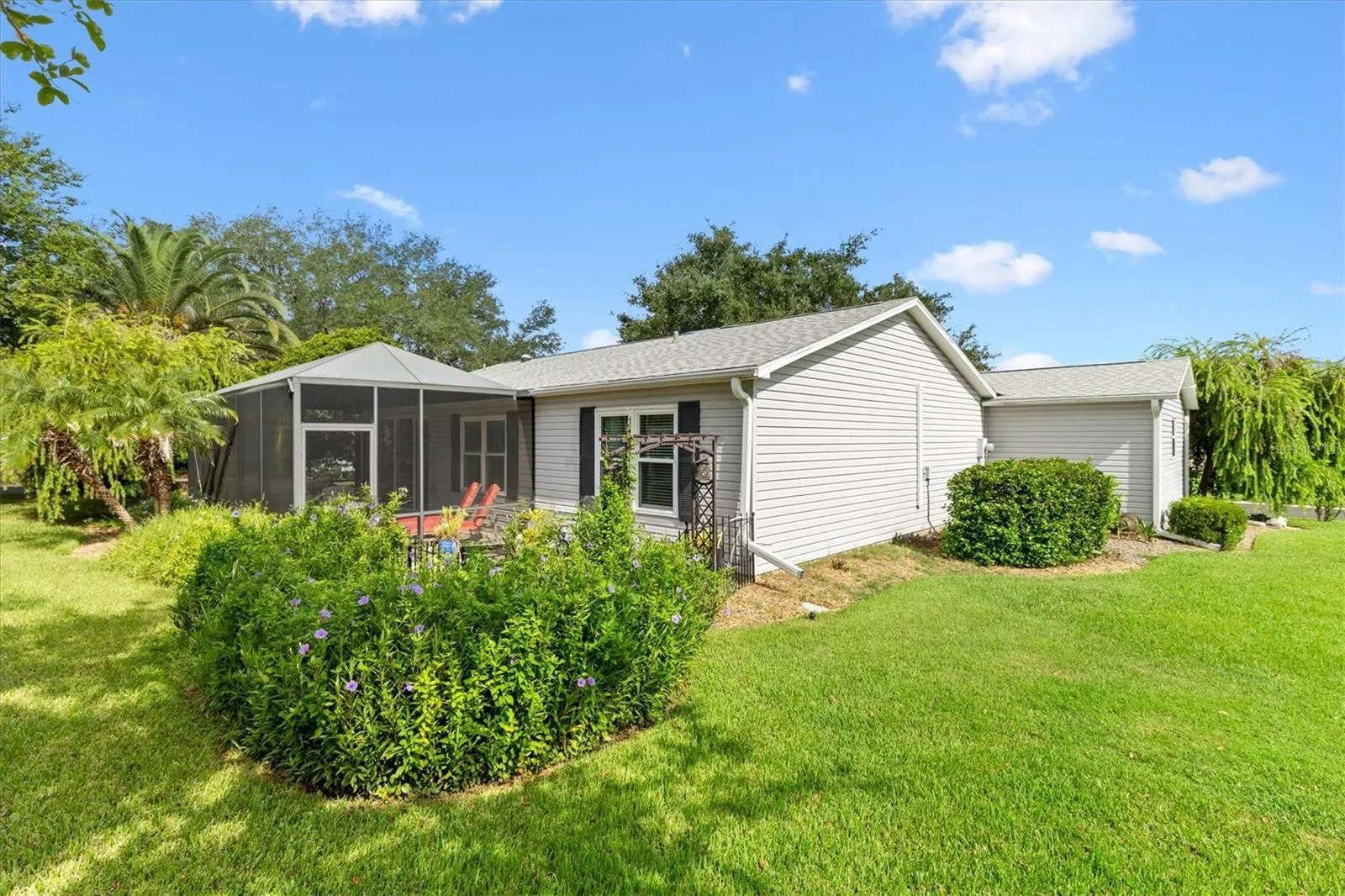 BACK OF HOME WITH  BEAUTIFUL LANDSCAPING