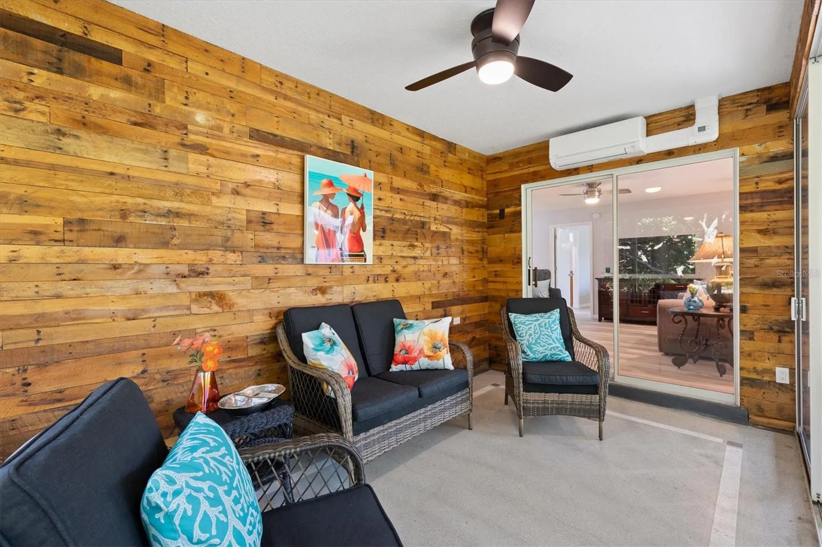 GLASS ENCLOSED LANAI STACKING SLIDING DOORS WITH MINI SPLIT/ AIR CONDITIONING FOR ALL AROUND COMFORT WITH TINTED WINDOWS FOR PRIVACY