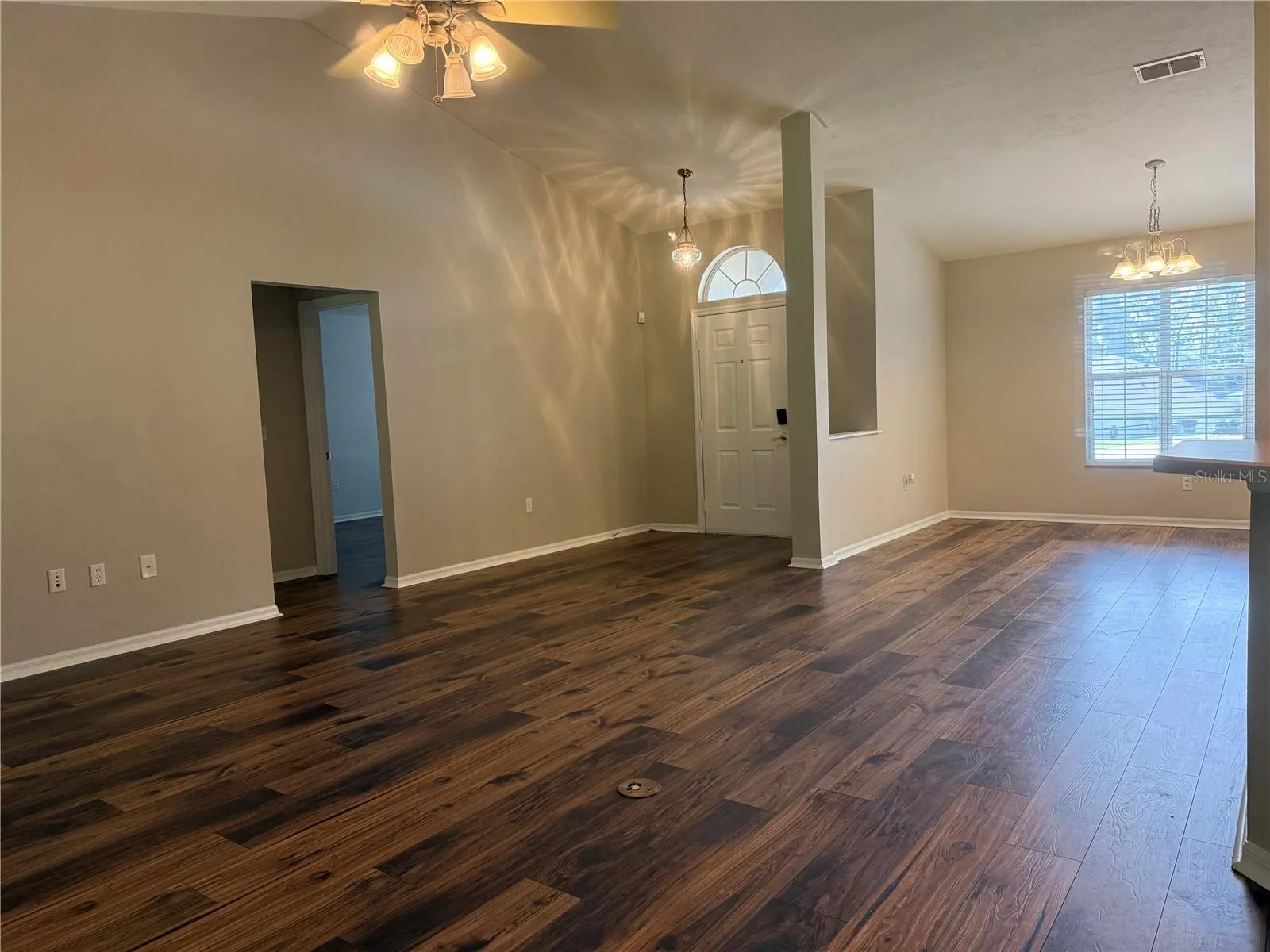 View from dining nook to living room area &amp; front door