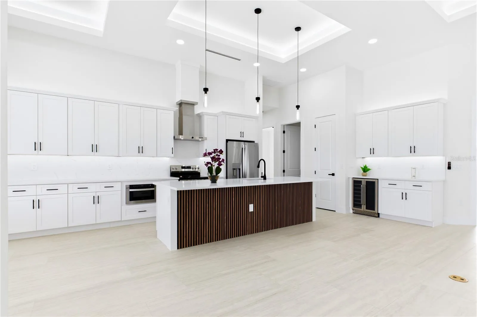STUNNING CHEF’S KITCHEN w/ sophisticated CUSTOM CABINETRY w/ crisp WHITE SHAKER CABINETRY.