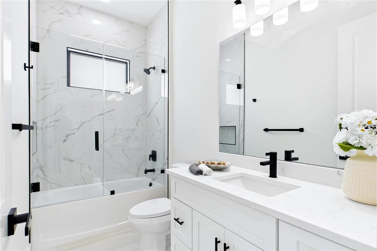 STYLISH HALL BATHROOM makes everyday routines effortless w/ a bright modern design, QUARTZ vanity &amp; beautifully tiled TUB/SHOWER. Perfectly positioned for FAMILY &amp; GUESTS while maintaining the home’s cohesive CONTEMPORARY STYLE!