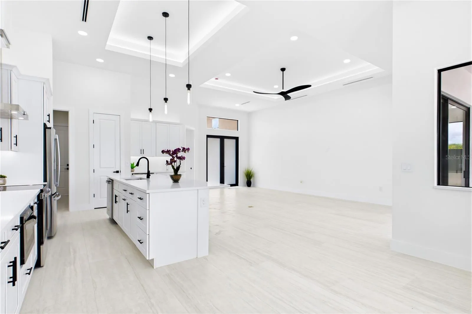 Living, dining, kitchen, and primary suite feature RECESSED CEILINGS accented by sleek LED TRACK lighting.