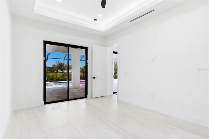 LARGE PRIMARY SUITE w/ sliding doors to lanai, WALK-IN CLOSET w/ BUILT-IN SHELVING &amp; HANGING RACKS &amp; LUXURIOUS PRIMARY BATHROOM