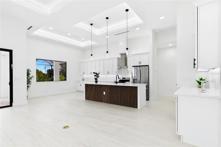 QUARTZ COUNTERTOPS &amp; FULL-HEIGHT QUARTZ BACKSPLASH w/ clean modern palette, while UNDER-CABINET LED LIGHTING enhances bright, open ambiance.