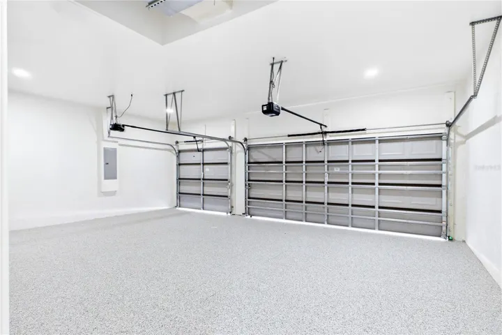 SPACIOUS 3-CAR GARAGE w/ durable EPOXY FLOORING offers plenty of room for vehicles, storage, bikes, water toys &amp; all your SWFL LIFESTYLE essentials!