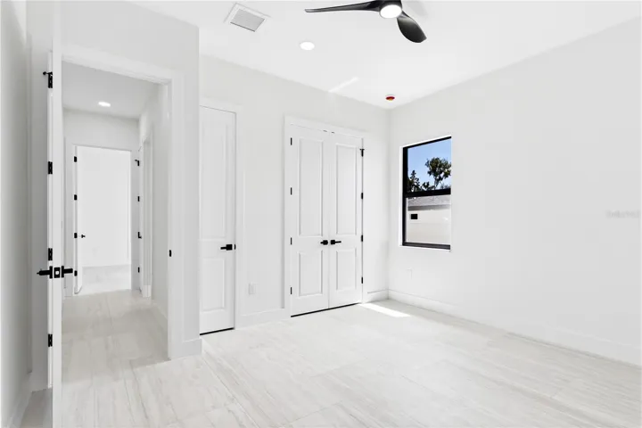 A COMFORTABLE THIRD BEDROOM offers a bright, peaceful retreat for FAMILY or GUESTS w/ modern finishes &amp; generous closet space.