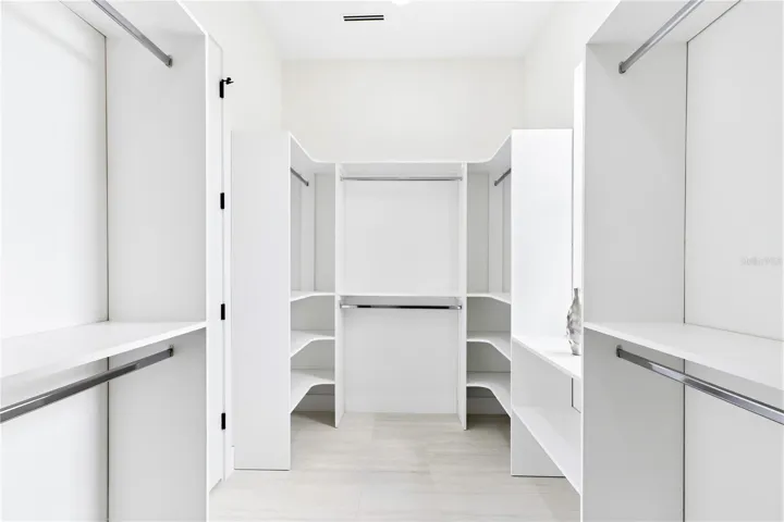 START &amp; END YOUR DAY ORGANIZED w/ an expansive CUSTOM WALK-IN CLOSET offering abundant built-in shelving &amp; hanging space for effortless everyday living!