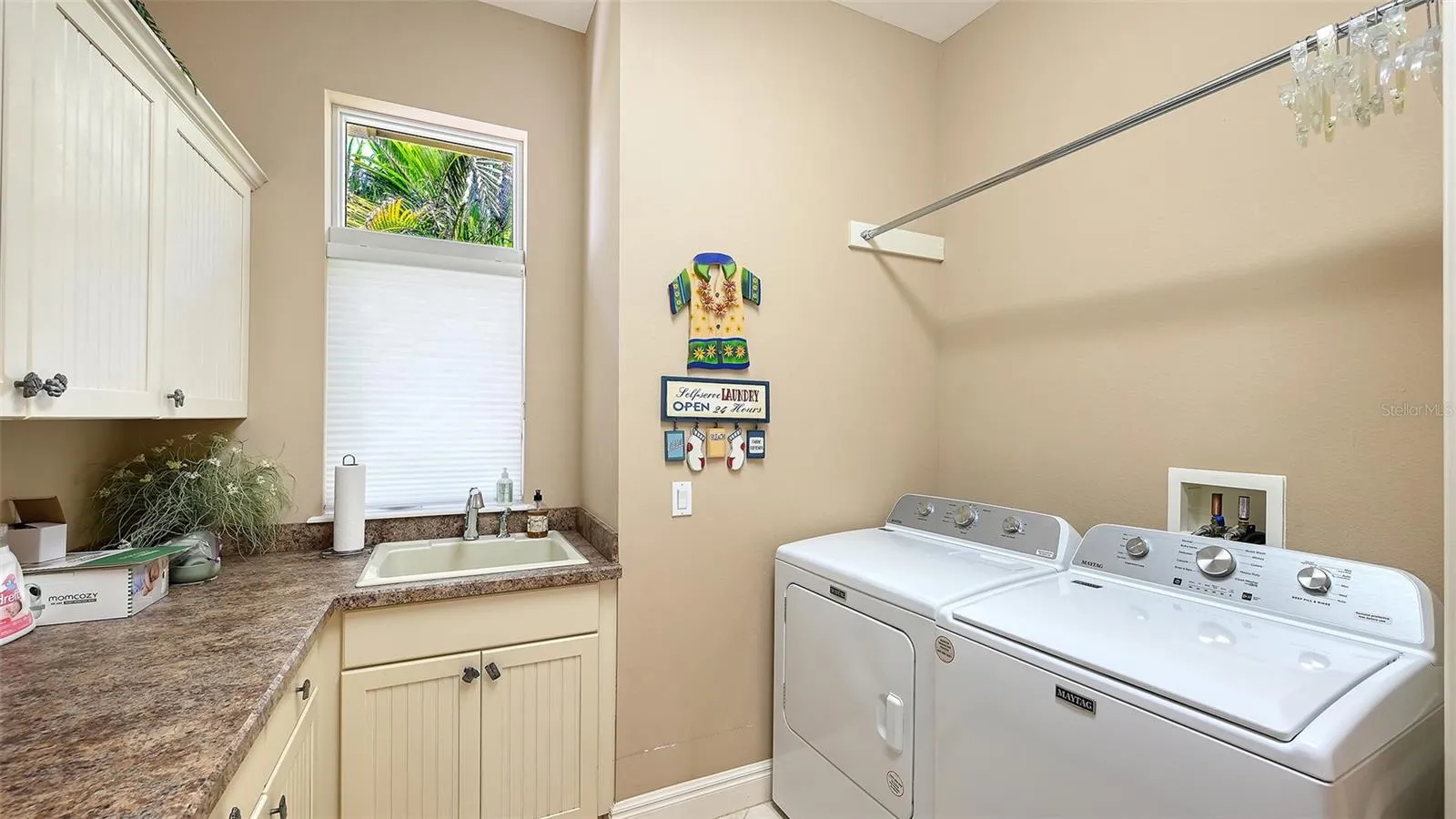 Laundry room with lots of hanging space, folding space and storage for your cleaning supplies.