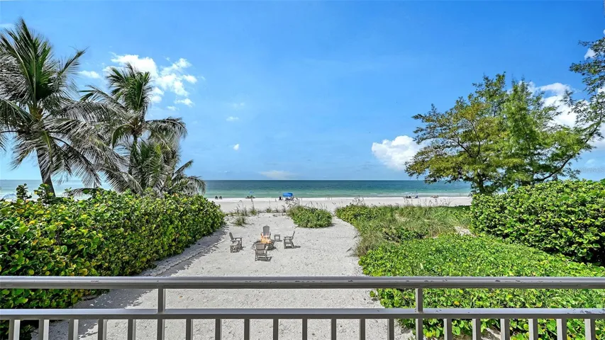 View from the living room of the private beach and the public beach past the sea oats.