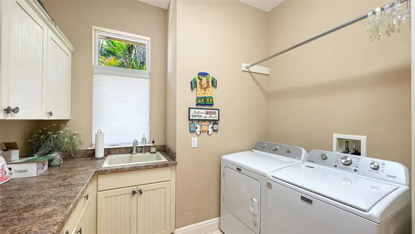 Laundry room with lots of hanging space, folding space and storage for your cleaning supplies.
